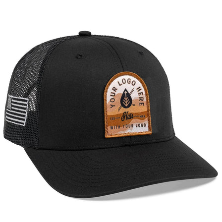 The C12-CTM Black Mesh Trucker Hat by BLVNK features bold white Custom cursive with YOUR LOGO HERE text on the front panel, offering a stylish way to showcase branded hats that reflect your style or logo.