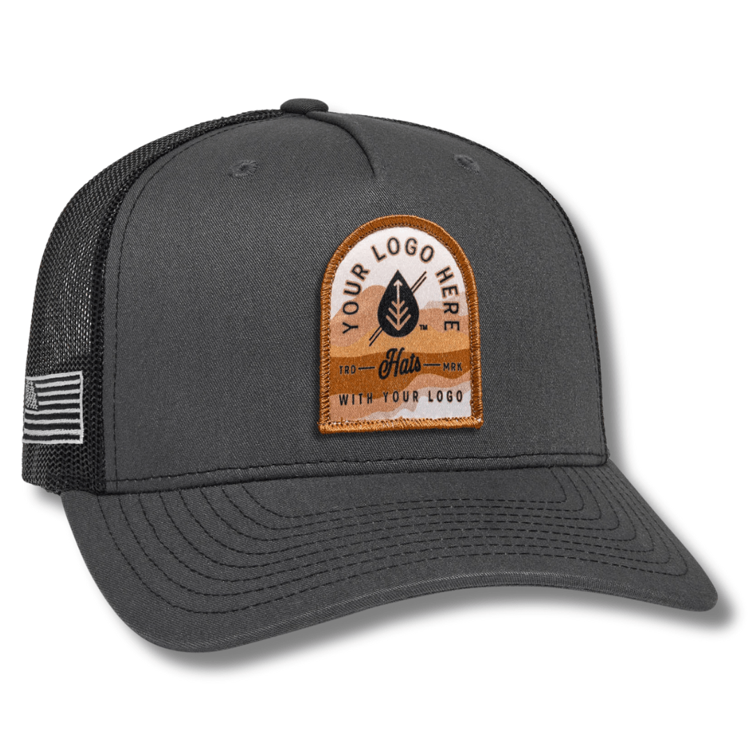 The Richardson 112FP 5-Panel Snapback Trucker Hat features a black front with Custom in white script and YOUR LOGO HERE stitched below, ideal for those seeking standout personalized hats with logos.