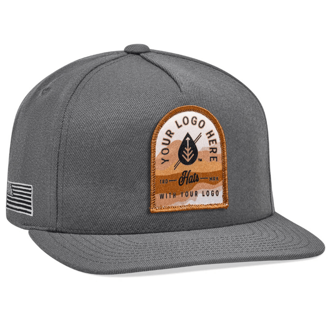 The Yupoong 5089M High-Profile 5-Panel Flat Bill Snapback Hat is gray with white embroidered Custom - Your Logo Here text on the front, perfect for company logos. It features a flat brim and a side patch with a flag design.