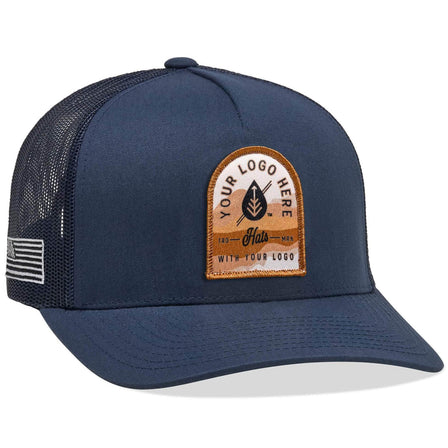 A Yupoong 6506(T) – 5-Panel Trucker Hat in navy blue with Custom Your Logo Here embroidered in white on the front, featuring a mesh back and side patch, perfect for showcasing your company logo.