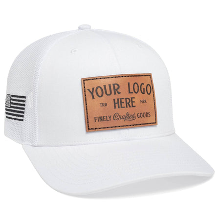 The Richardson 112 Trucker Hat is a white mesh-back cap featuring bold black embroidered Custom - Your Logo Here text and an embroidered U.S. flag on the side, perfect for customizing with your company logo in bulk.