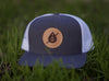 C52-WM wool trucker hat with leather patch logo in grass
