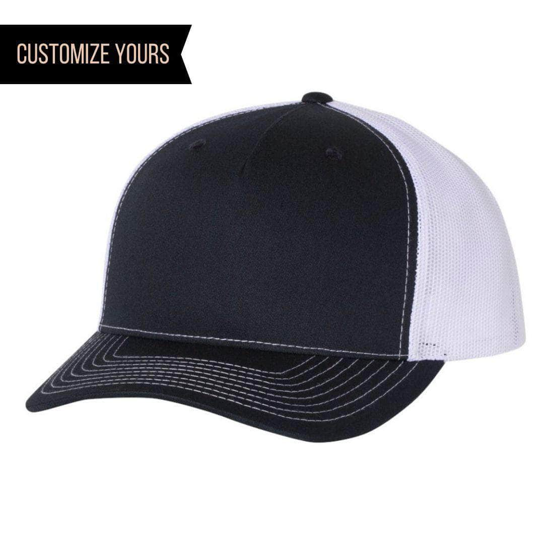 The Richardson 112FP features a navy front panel and white mesh back, ideal for corporate logo hats. CUSTOMIZE YOURS is on the top left corner. It includes black stitching on the bill for a sleek finish.